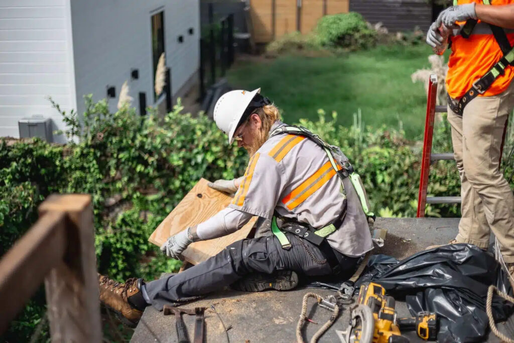 Roof repair work being performed by Benify Exteriors technician